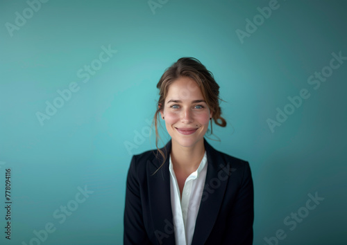 Professional Business Woman Smiling Against Vibrant Teal Background - Corporate, Leadership, and Diversity Visuals. photo