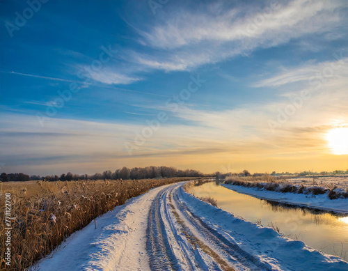 view of the fields and river in winter at sunset