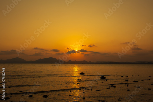 Sunset or evening time over sea water. © Phongsak