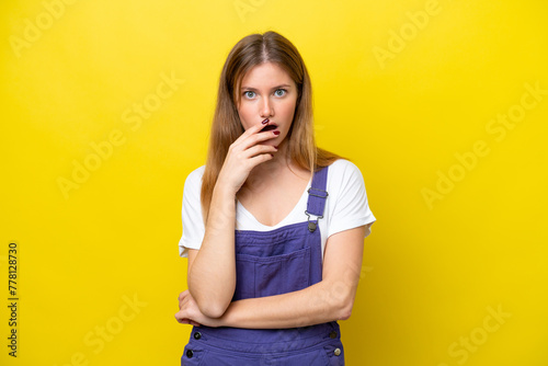 Young caucasian woman isolated on yellow background surprised and shocked while looking right
