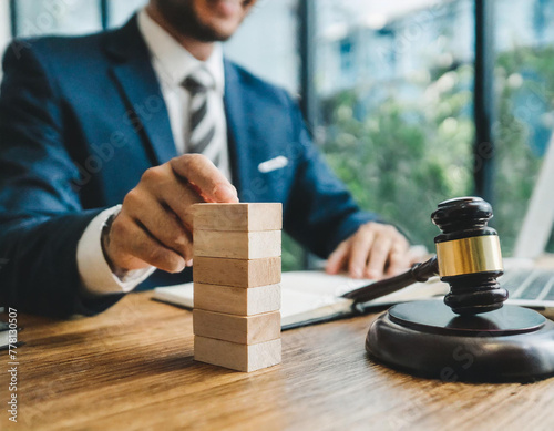 Legal consultant and lawyer concept. Businessman stacking wooden block with law law legal justice icon. Legal advice in Labor law for a business company legal