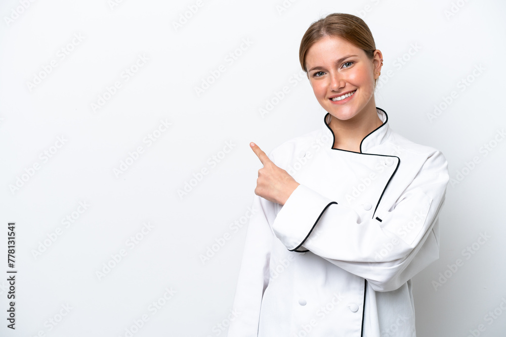 Young chef woman isolated on white background pointing to the side to present a product Young chef woman isolated on white background pointing to the side to present a product