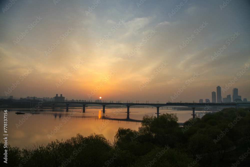 The morning sun rising above the Han River Bridge in Seoul