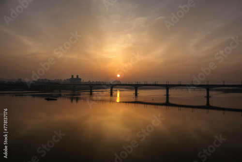 The morning sun rising above the Han River Bridge in Seoul