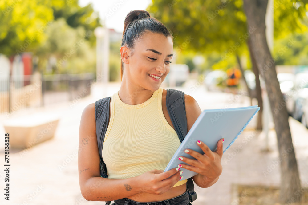 Young pretty student woman at outdoors with happy expression Young pretty student woman at outdoors with happy expression