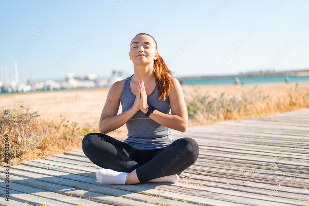 Young pretty sport woman doing yoga