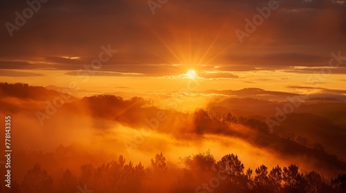 The sun is setting over a foggy mountain range © esp2k