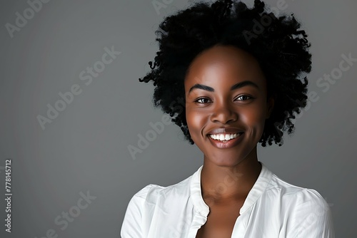 Beauty portrait of african american woman with clean healthy skin on white background. Smiling dreamy beautiful afro haitstyle girl. Curly black hair photo