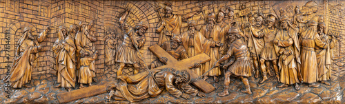 MILAN, ITALY - MARCH 5, 2024: The carved relief  Fall of Jesus under the cross  in the church Chiesa di San Camillo by Annibale Pagnoni (1900).