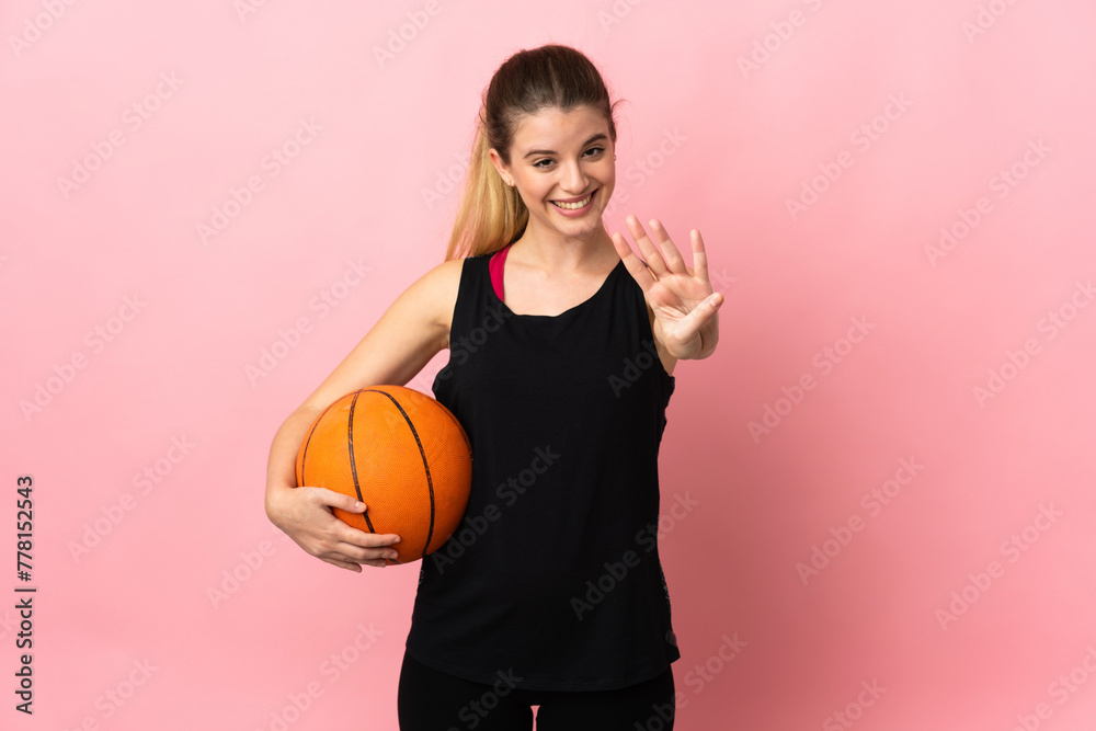 Young blonde woman playing basketball isolated on pink background happy and counting four with fingers