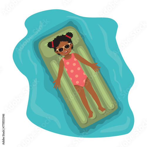 Cute little African girl in swimsuit sunbathing having fun lying on inflatable mattress