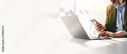 Typing on a smartphone Working online on laptop, computer and smartphone on white table at office. Facebook chat. Web meeting. Blogger. Journalist writing an article. online job idea