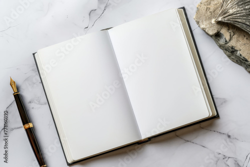 Mockup of an open classic hardcover notebook with a fountain pen on marble surface photo