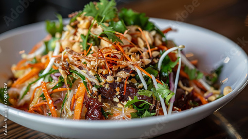 Vibrant vietnamese salad with herbs, nuts, and dressing in a white bowl