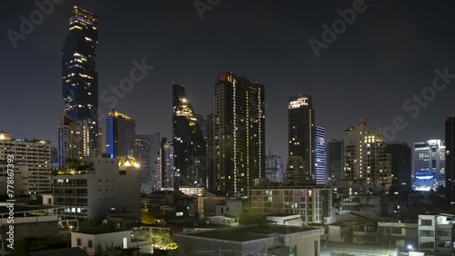 Night timelapse of skyscraper buildings in Bangkok in Bang Rak district. photo