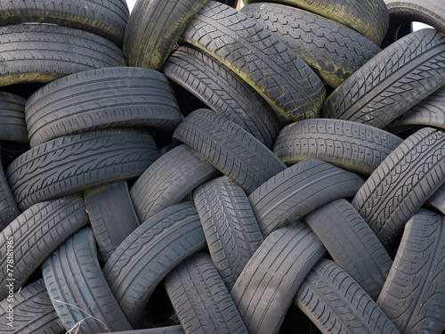 Stacked used tyres abandoned on site of former garage