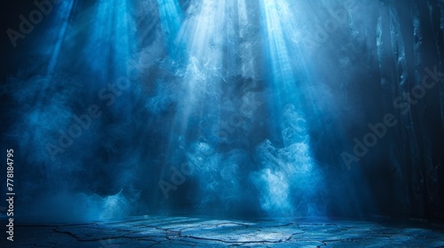 Intense beams cut through mist on an empty stage.