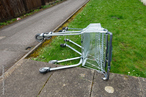 Photography Abandoned Shopping Trolleys on a Grass Verge in a Town on their Side Next To A P