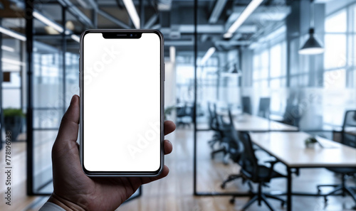mockup hand holding a smartphone with transparent background with an office blurred in the background 
