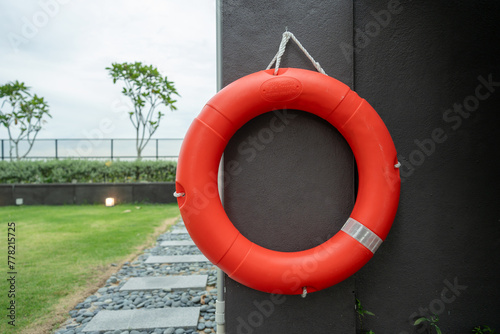A lifebuoy hangs on the wall of the apartment's shared swimming pool.