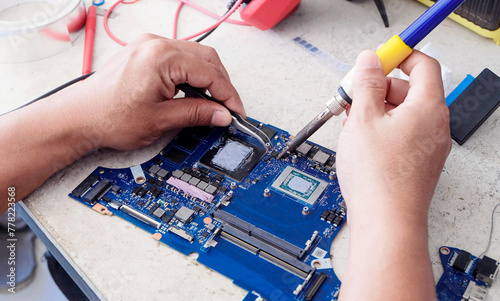 Computer repair technician and internal equipment, motherboard.