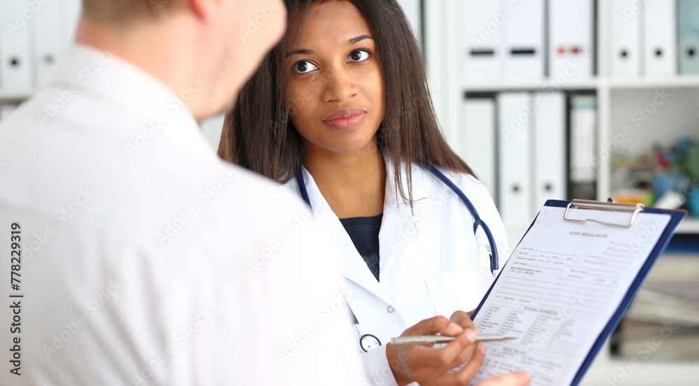 Female doctor hand hold silver pen and showing pad. Physical agreement form signature disease prevention ward round reception consent contract sign prescribe remedy healthy lifestyle concept Female doctor hand hold silver pen and showing pad. Physical agreement form signature disease prevention ward round reception consent contract sign prescribe remedy healthy lifestyle concept