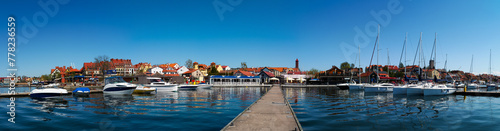 2023-04-22; panorama Mikolajskie Lake of town, marina for yachts and boats at the waterfront. Mikolajki, Poland.