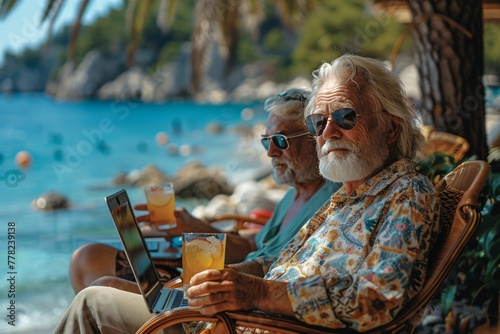 Happy seniors embrace tech while lounging with laptops