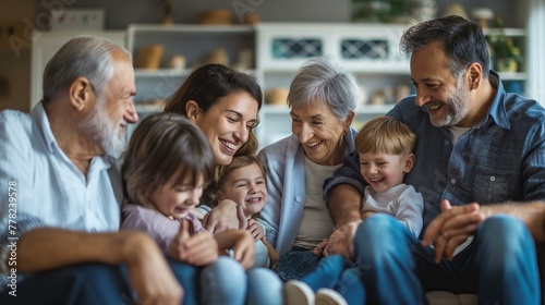 A family of five, including a grandfather and his grandchildren, are sitting on a couch and smiling