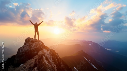 A man is standing on a mountain peak, with the sun shining brightly behind him. Concept of accomplishment and triumph, as the man has reached the top of the mountain