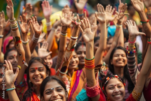 A large group of women from various backgrounds raising their hands in unison at a cultural event or festival