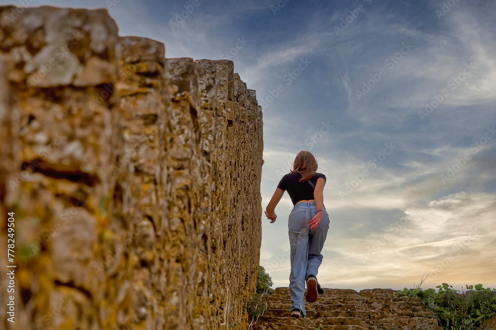 Naklejka premium A young woman in an ancient fortress