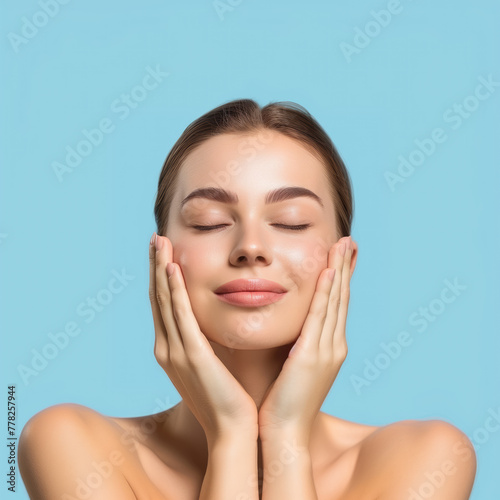 young woman with closed eyes gently touches her face