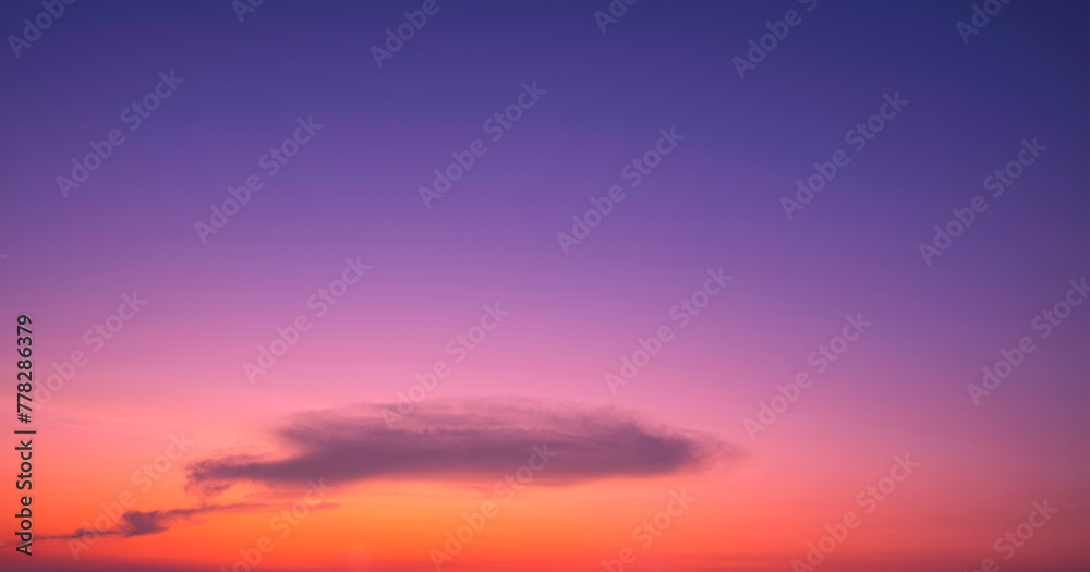 Colorful twilight sky background with silhouette cloud on romantic orange, pink and blue idyllic evening sky after sundown, beautiful sunset skyscape in minimal style