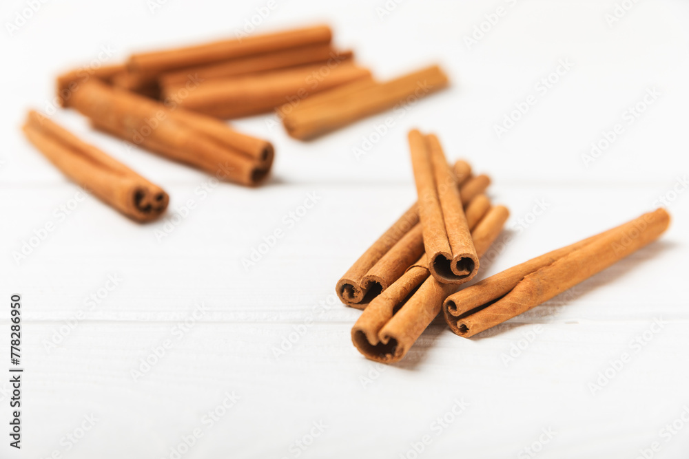 Cinnamon sticks on a textured wooden background. Cinnamon roll. Spicy spice for baking, desserts and drinks. Fragrant ground cinnamon. cinnamon powder Close-up. Place for text. copy space Cinnamon sticks on a textured wooden background. Cinnamon roll. Spicy spice for baking, desserts and drinks. Fragrant ground cinnamon. cinnamon powder Close-up. Place for text. copy space