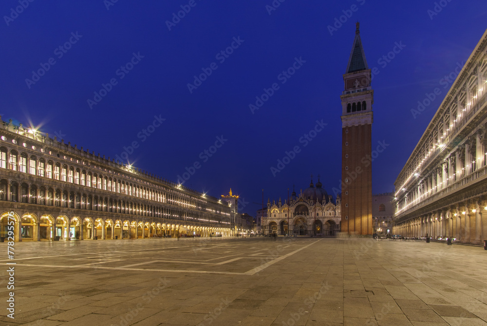 An empty illuminated San Marco square with the bell tower and the cathedral at blue hour on a winter evening, Venice, Veneto, Italy