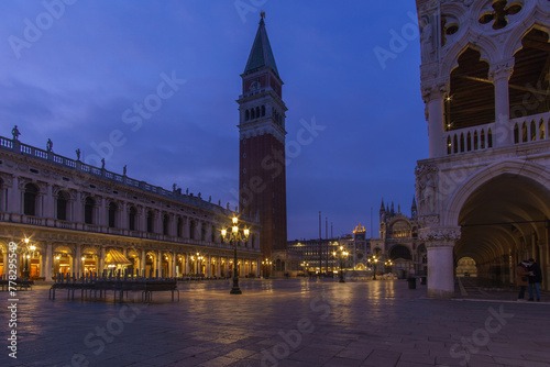 An empty illuminated San Marco square with the bell tower and Doge Palace at blue hour on a winter evening, Venice, Veneto, Italy
