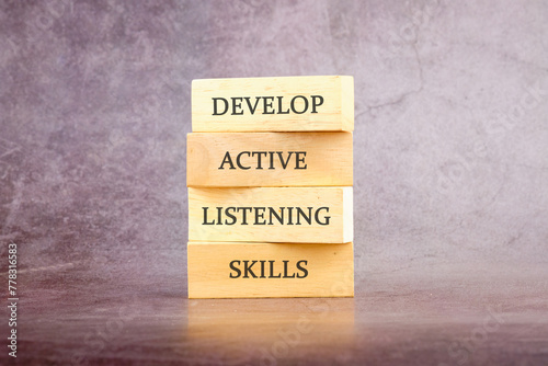 Concept word Develop active listening skills on wooden blocks. The concept of a business idea