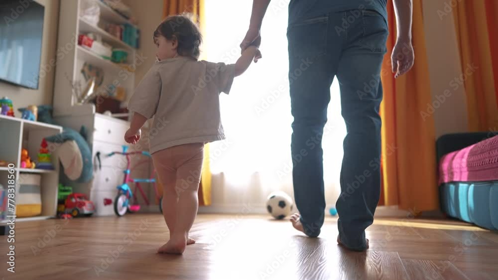 baby first steps with dad. happy family a kid dream concept. dad and baby daughter walk along the corridor of the house indoors. dad and daughter care, hold hands, walk, lifestyle take first steps baby first steps with dad. happy family a kid dream concept. dad and baby daughter walk along the corridor of the house indoors. dad and daughter care, hold hands, walk, lifestyle take first steps