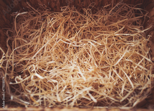 Decorative straw, filler, shavings for box. Top view, mockup for design. hay straw bird's nest dry grass, sawdust, shavings. Selected focus, abstract background. 
