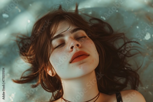 a young woman modeling resting face with closed eyes and clear skin