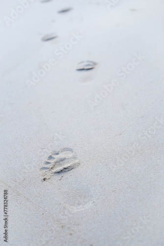 Wave footprints on the sand beach, nature summer on the sandy beach near the sea shore. Tourist travel concept. Vertical.