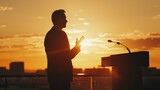 Silhouette of a leader giving a speech on a rooftop, sunset glow, eye level, engaging, powerful moment.