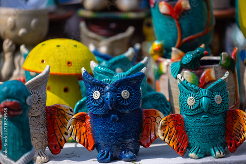 Handmade clay toys,  Handmade toys made with clay of colourful owls for Kids in display at Surajkund Craft Fair. Selective focus.