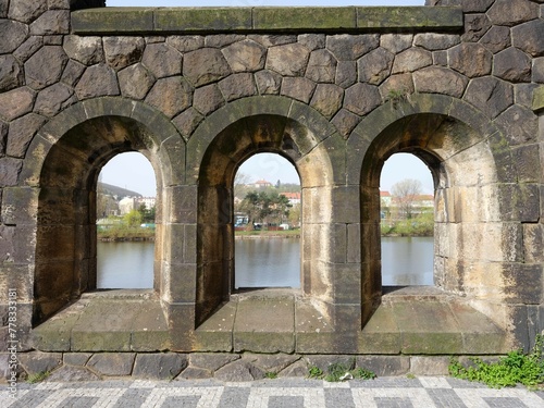 Stone arch windows against river of Vltava in Prague, zcech republic