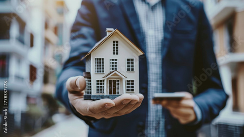 estate agent holding house