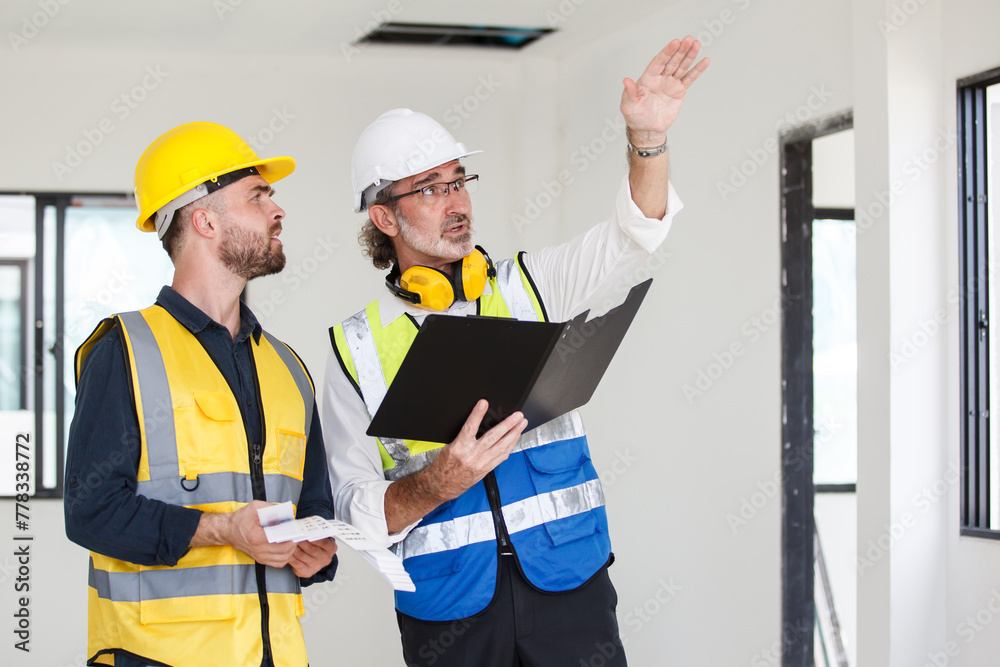 Foreman and client discuss on a building plan and construction. Foreman and client discuss on a building plan and construction.