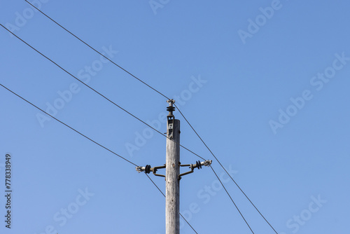 A high voltage transmission pole with three wires on standoff insulators