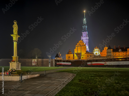 Jasna Gora Monastery and the column with the Blessed Virgin Mary in Czestochowa at night. The inscription on the banner in Polish "Jesus meets his mother"