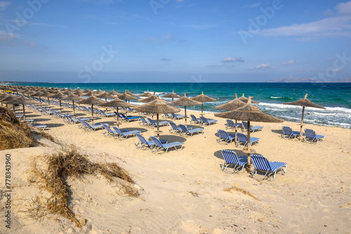 Sunbeds with umbrella on sandy beach of Marmari. The Greek island of Kos © vivoo